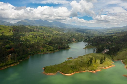 A lake among the hills with tea plantations in the mountains. Maskeliya, Castlereigh, Sri Lanka.