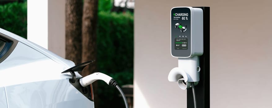 Electric vehicle technology utilized to residential home charging station for EV car battery recharge. Eco-friendly transport by clean and sustainable energy for future environment.Panorama Synchronos