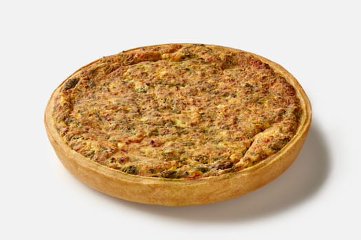 Delicious traditional French quiche with crispy shortbread crust filled with savory custard, cheese and spinach, isolated on white background