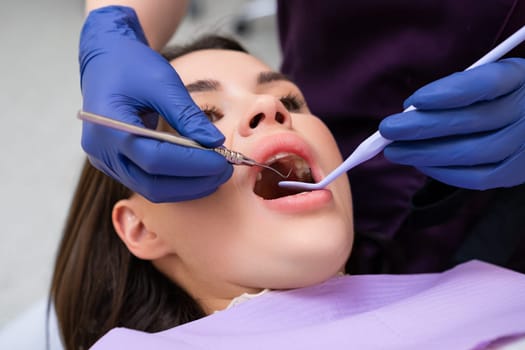 Dentist examining a patients teeth in dental office