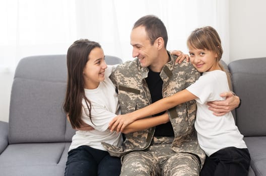 Soldier with his little children at home. High quality photo