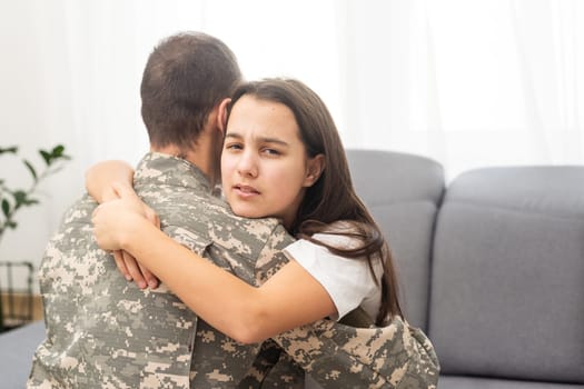 pretty little girl hugging her military father. High quality photo