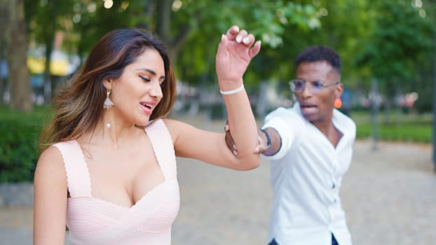 Man arguing with a woman on the street and grabbing her arm