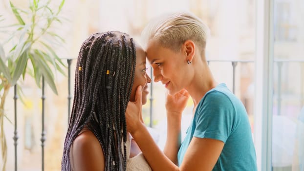 Love moment between a lesbian couple relaxed at home