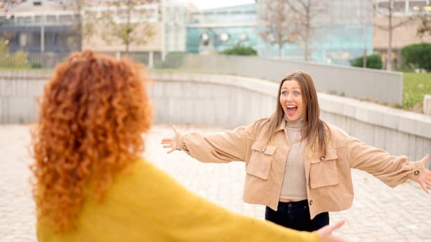 Happy moment of a meeting of two women in the street