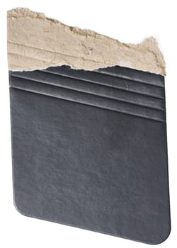 Piece of black cardboard with torn edges on isolated background, close up