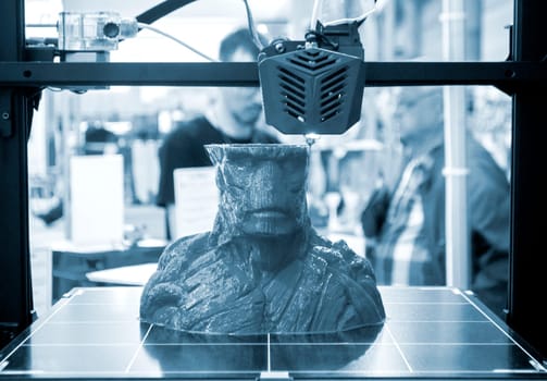 The process of printing an object with 3D printer. 3D printer printing a model from molten plastic. 3D printing. Robotic creation of mold form. Automated creation prototyping of 3D printers technology