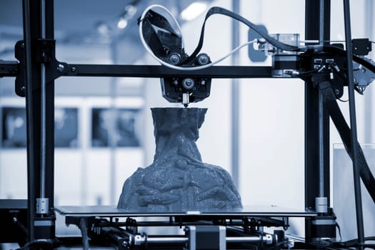 The process of printing an object with 3D printer. 3D printer printing a model from molten plastic. 3D printing. Robotic creation of mold form. Automated creation prototyping of 3D printers technology