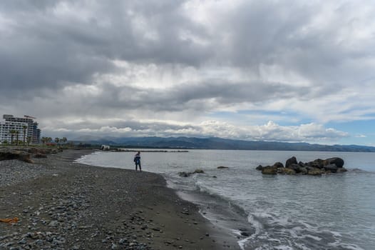 woman walking along the seashore in winter in Cyprus 4