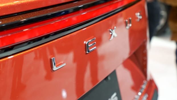Red Lexus car brand close up view. Brand of Japanese automobiles produce premium vehicles, luxury cars. Toronto ON Canada - Feb 19, 2023