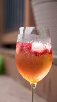 Fresh summer cocktail with strawberry and ice cubes. Glass of strawberry soda drink on dark background. Fresh strawberry cocktail