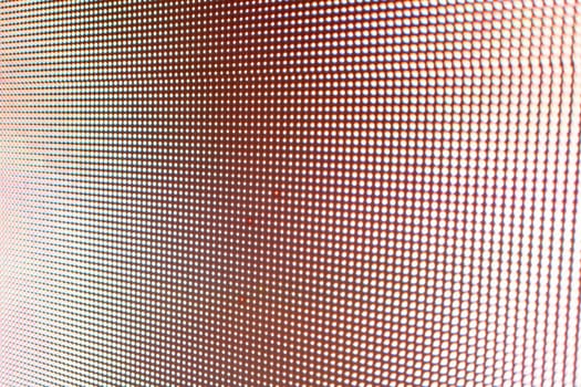 Abstract light gradient texture displayed on an LED screen with red color palette, creating visually dynamic abstract background texture.
