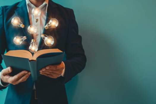 Portrait of man reading book and a light bulb, reading books for inspiration or looking for ideas.