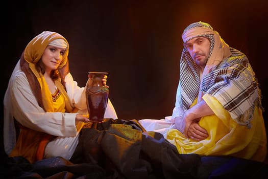 A couple in love or a married couple in stylized Eastern clothing from Israel, Palestine, Iran, Pakistan together. Tender photo session in the style of the Middle East and the Bible