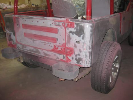 Auto Body Repair and Repainting Prep Work on Red Vehicle. High quality photo