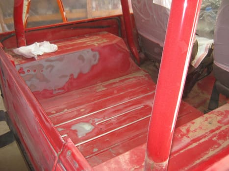 Auto Body Repair and Repainting Prep Work on Red Vehicle. High quality photo