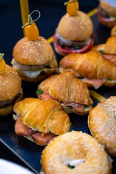 croissants with salmon and boogers in close-up on the catering table.