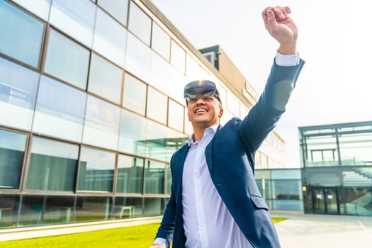 Businessman gesturing in the air using augmented vision goggles outside the office