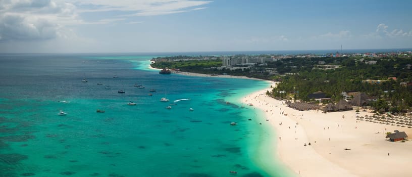 Zanzibar beach where tourists and locals mix together of colors and joy, concept of summer vacation, aerial view of Kendwa beach, Tanzania