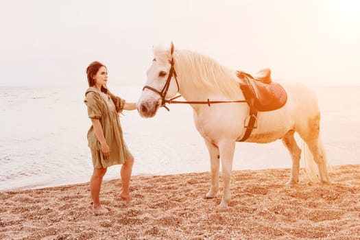 A white horse and a woman in a dress stand on a beach, with the sky and sea creating a picturesque backdrop for the scene