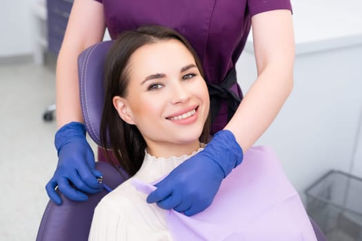 Beautiful brunette woman having dental treatment at dentists office