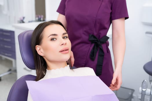 Young beautiful woman in dentists chair before a checkup in the clinic.