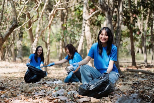 Group of volunteers, community members cleaning the nature from garbage and plastic waste to send it for recycling.