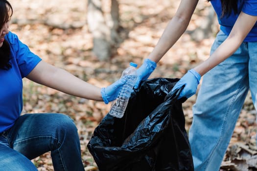 Group of volunteers, community members cleaning the nature from garbage and plastic waste to send it for recycling.