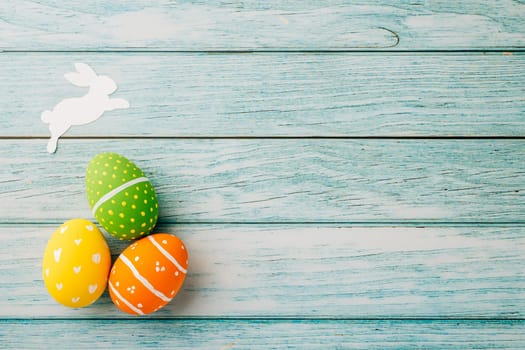 Easter Day Concept. Top view holiday banner background web design white colorful easter eggs painted on blue wood background with empty copy space, celebration greeting card, overhead, template