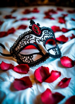 black lace mask on the bed. Selective focus. rose.