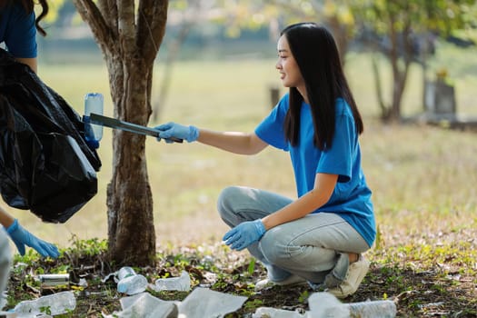 Group of volunteers, community members cleaning the nature from garbage and plastic waste to send it for recycling.