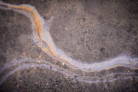 A colorful stain of engine oil on the road