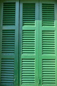 old green shutters in a house in the village