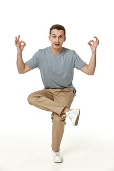 young man smiling jumping high isolated on white background