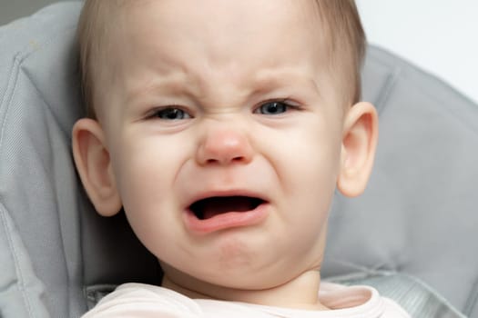 Closeup portrait of a baby in distress, crying out of hunger and tiredness