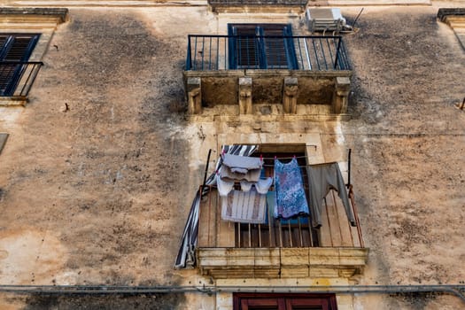 noto sicily baroque town building clothes hanging