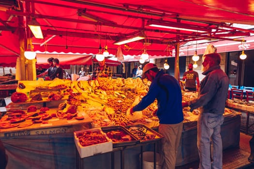 Catania, Italy - November 1, 2019: Seafood at fish market in Catania, Sicily, Italy. Fresh fish at the fish market in the old Town of Catania in the province of Sicily in Italy. 