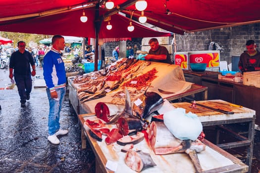 Catania, Italy - November 1, 2019: Seafood at fish market in Catania, Sicily, Italy. Fresh fish at the fish market in the old Town of Catania in the province of Sicily in Italy. 
