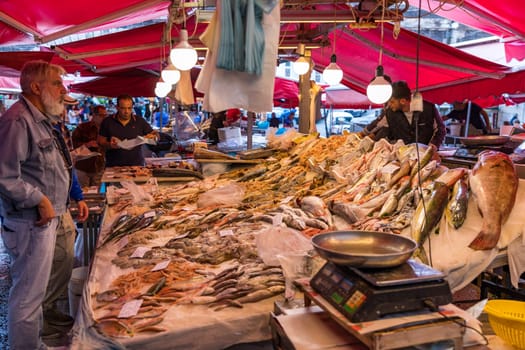 Catania, Italy - November 1, 2019: Seafood at fish market in Catania, Sicily, Italy. Fresh fish at the fish market in the old Town of Catania in the province of Sicily in Italy. 