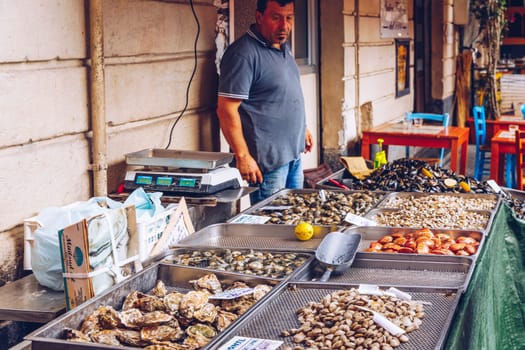 Catania, Italy - November 1, 2019: Seafood at fish market in Catania, Sicily, Italy. Fresh fish at the fish market in the old Town of Catania in the province of Sicily in Italy. 
