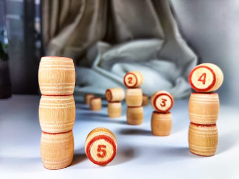 Small wooden barrels with numbers built in columns. The concept of duration and ways to achieve the goal. The sequence of actions to obtain the effect and result