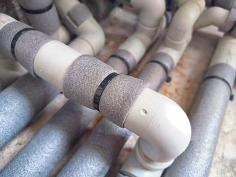 Complex Network of Insulated Pipes in an Industrial Setting. maze of thermally insulated pipes arranged in a complex network, part of an industrial heating or cooling system