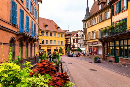 Colmar, France - July 27, 2018: Old town of Colmar, Alsace, France. View with colorful buildings, canal and flowers. Colmar, France. Petite Venice, water canal and traditional half timbered houses.