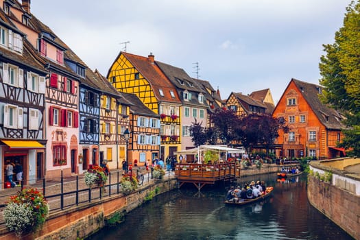 Colmar, France - July 27, 2018: Old town of Colmar, Alsace, France. View with colorful buildings, canal and flowers. Colmar, France. Petite Venice, water canal and traditional half timbered houses.