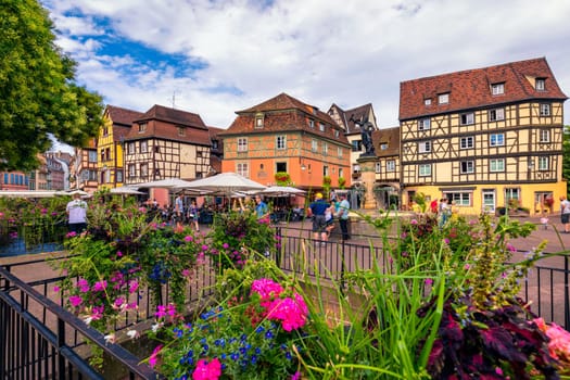 Colmar, France - July 27, 2018: Old town of Colmar, Alsace, France. View with colorful buildings, canal and flowers. Colmar, France. Petite Venice, water canal and traditional half timbered houses.