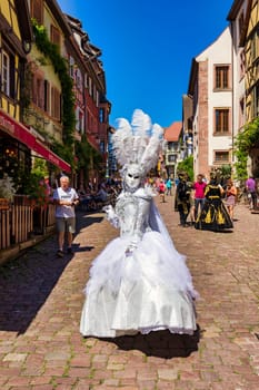 Riquewihr, France - 2 July 2022: Venetian Parade in Riquewihr. Most beautiful villages of France, Riquewihr in Alsace, famous "vine rote". Colorful town of Riquewihr, Alsace, France.