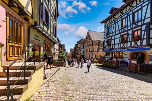 Riquewihr, France - July 2, 2022: Riquewihr village on Alsatian Wine Route, France. Most beautiful villages of France, Riquewihr in Alsace, famous "vine rote". Colorful town of Riquewihr, France.