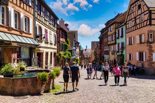 Riquewihr, France - July 2, 2022: Riquewihr village on Alsatian Wine Route, France. Most beautiful villages of France, Riquewihr in Alsace, famous "vine rote". Colorful town of Riquewihr, France.