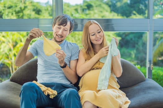 In a heartwarming scene, the future mom and dad hold their unborn baby's clothes in their hands, savoring the joy of anticipation and shared excitement for their little one's arrival.