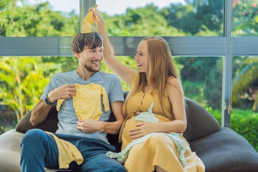 In a heartwarming scene, the future mom and dad hold their unborn baby's clothes in their hands, savoring the joy of anticipation and shared excitement for their little one's arrival.